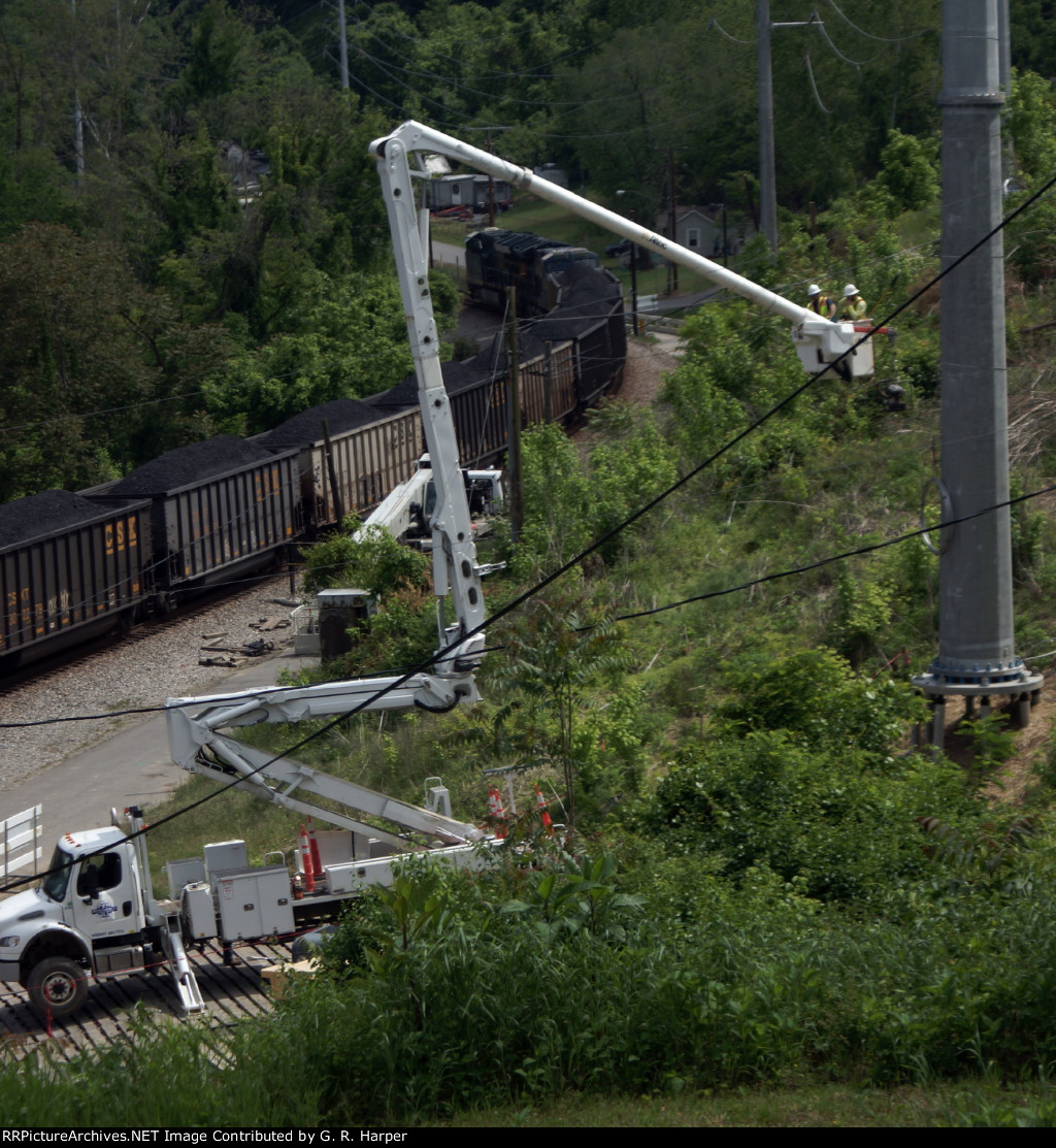 Bucket crane frames an eastbound coal train.